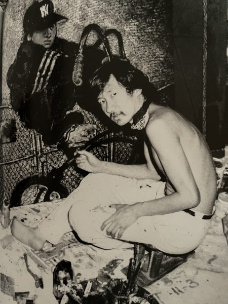 The painter Martin Wong shirtless at work in his studio